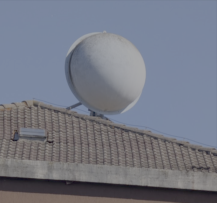 Microwave relay dish on a railroad station roof